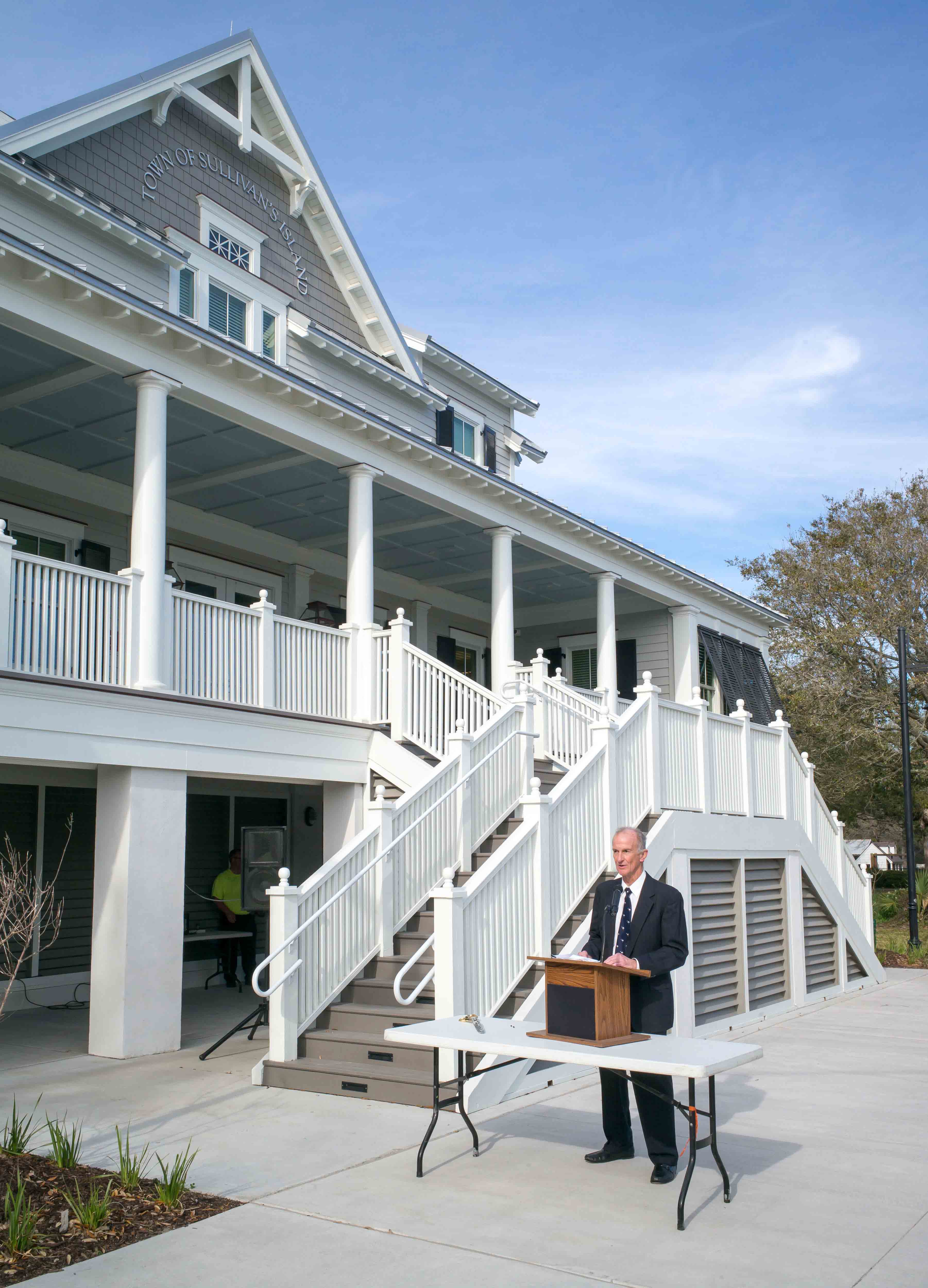 Exterior of Sullivan's Island Town Hall with man at podium