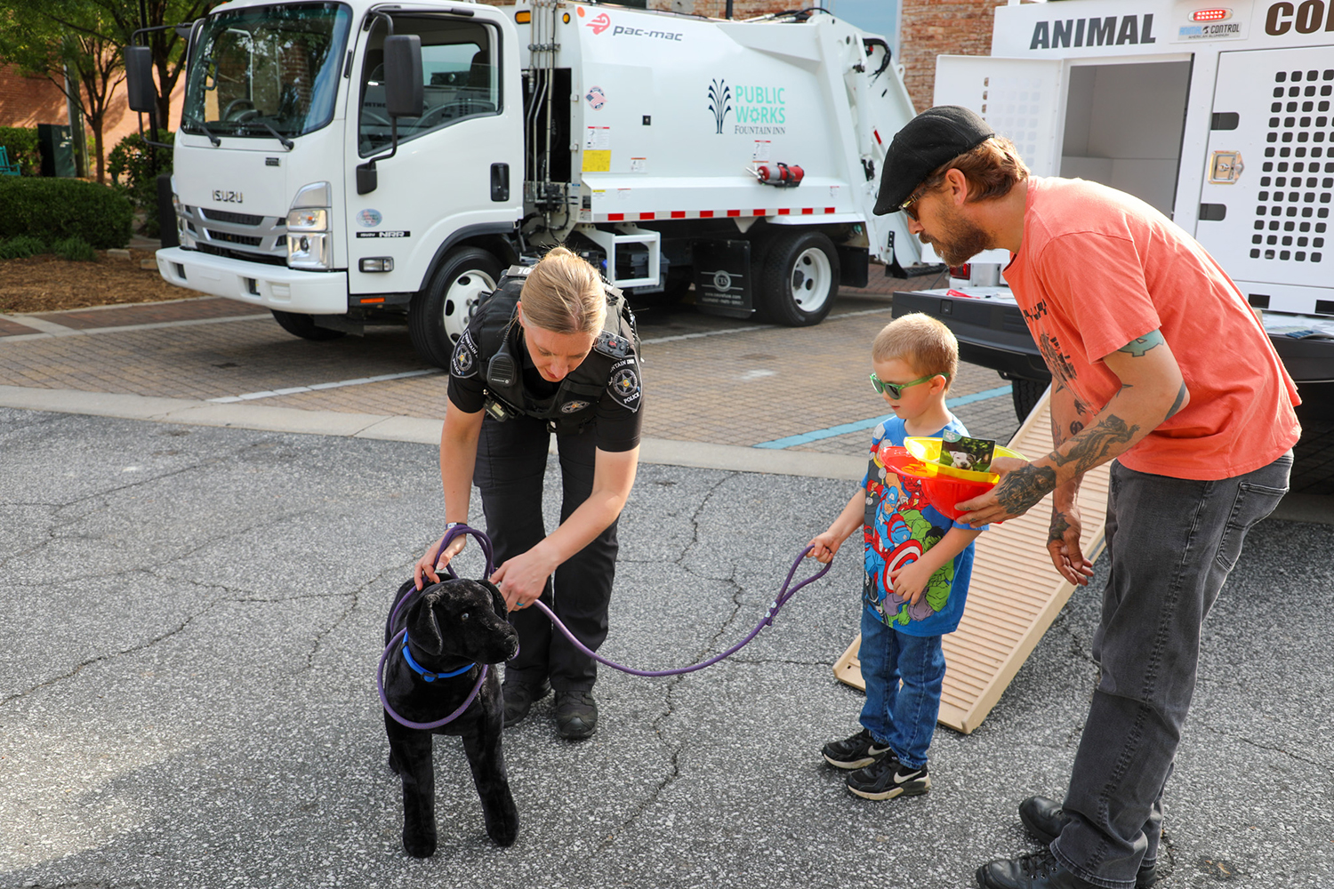 Rebekah Ward, animal control officer for the City of Fountain Inn, demonstrates safe animal handling techniques on a model dog. Photo: City of Fountain Inn.